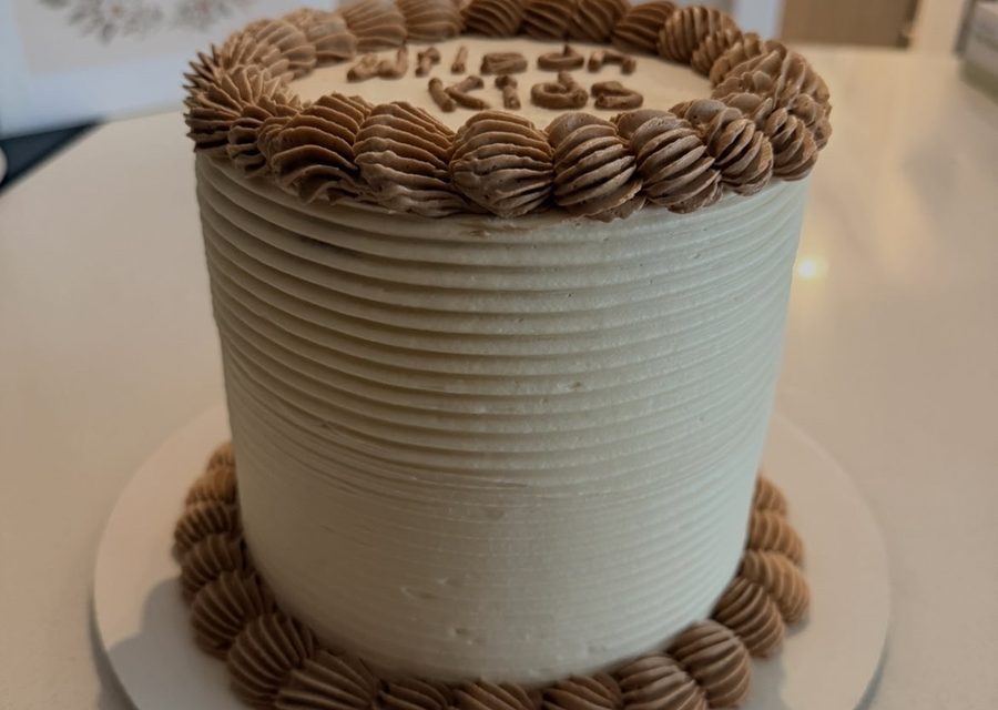 Tall chocolate buttercream cake with a piped shell border