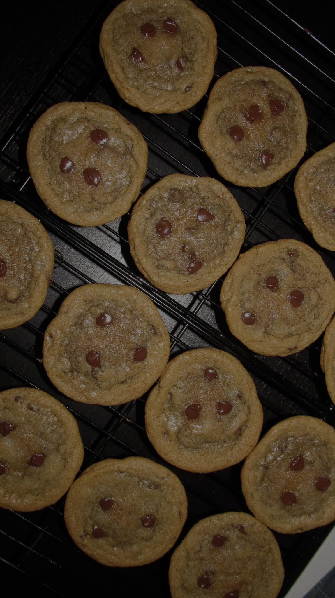 Fresh chocolate chip cookies cooling on a rack