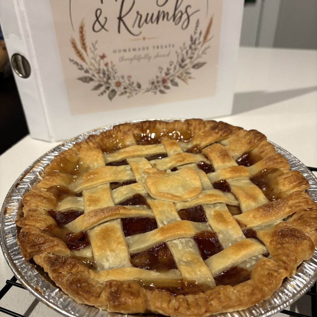 Whole apple pie with a hand-woven lattice crust